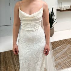 a woman in a white wedding dress is posing for the camera while wearing a veil