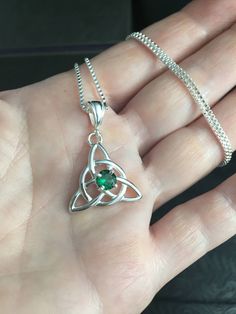 Did you enjoy Charmed, the TV show? I'll fabricate this sterling silver Celtic Trinity Knot pendant, approximately 1 inch in diameter, and I will set your choice of a 6mm round faceted or cabochon gemstone from the drop down menu. This comes with a 16 inch sterling silver box chain at 1.2mm thickness with a lobster claw for secure attachment. This is shown with a classic green Lab emerald faceted gemstone for the lucky lass in you! It's lovely, graceful and elegant...a timeless and classic tradi Spiritual Green Sterling Silver Jewelry, Silver Necklace For May Birthstone Anniversary, Silver Necklace For Anniversary With May Birthstone, Sterling Silver Pendant Necklace With May Birthstone, Sterling Silver Pendant Necklace For May Birthstone, Sterling Silver Necklace For May Birthstone Jewelry Making, Sterling Silver May Birthstone Necklace, Sterling Silver Necklace For May Birthstone, Silver May Birthstone Pendant Necklace