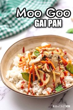 a bowl filled with rice and vegetables on top of a table