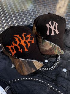 These hats are black and camo with an asymmetrical barbed wire trim. Default threads used are 100% rayon and offered in grey, blue, rose gold, white, rust orange, and champagne. HOWEVER, I have tons of thread options including woold thread in a multitude of colors. Please message for additional color options and I can send you photos of the threads I have available. Please also message me for additional lettering or symbols. Currently the metal font is default, however again, you can message me Curved Brim Hats For Fall Streetwear, Fall Streetwear Baseball Cap, Fall Streetwear Baseball Cap With Curved Brim, Streetwear Fall Baseball Cap With Curved Brim, Custom Embroidered Hats, Metal Font, Embroidered Hat, Rose Gold White, Barbed Wire