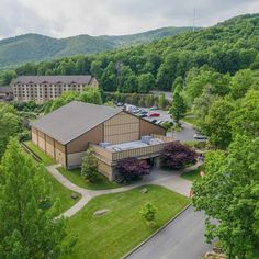 an aerial view of a building surrounded by trees