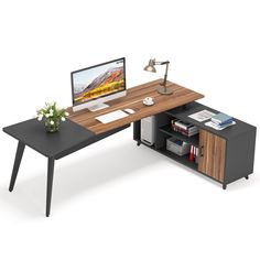 a computer desk with a monitor, keyboard and mouse on it in front of a white background