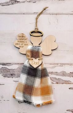 a wooden angel ornament hanging on a wall