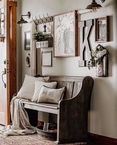 a living room filled with furniture and pictures hanging on the wall next to a door