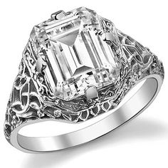 an emerald cut diamond ring with filigree accents