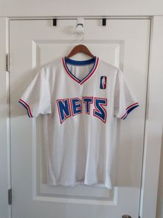 "Brooklyn Nets jersey in good condition, says AMO on back so it may be a sponsor but this is a very well made jersey. Size: fits like modern men's S or woman's M check additional measurements Pit to Pit      19\" Length         27\"" White Varsity Basketball Jersey, White Cotton Jersey For Sports Fans, White Cotton Fan Gear Jersey, White Basketball Jersey For Sports Season, White Baseball Jersey Fan Apparel, White Baseball Jersey For Streetwear, White Basketball Team Logo Tops, White Basketball Team Logo Top, Throwback White College Tops