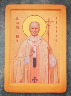 an icon of st john the baptist holding a cross on a yellow frame with black writing