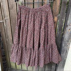 a skirt hanging on a wooden fence