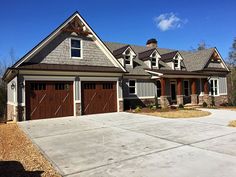 a large house with two garages in front of it