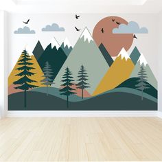 an empty room with wood flooring and wall mural depicting mountains, pine trees, birds flying in the sky