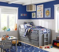 a child's bedroom with blue walls and white trim