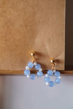 Elevate your ear game with our "Petals Hoop" earrings, meticulously handcrafted with alternating blue and white beads, reminiscent of delicate flower petals. These earrings are the epitome of elegance and sophistication, adding a touch of charm to any outfit. ✿ Details ✿ - Each hoop is meticulously handcrafted using high-quality blue and white beads, ensuring durability and timeless elegance. - Perfect for office wear, commuting, and urban style, these earrings add a sophisticated touch to any o Chunky Bead Earrings, Dangly Beaded Earrings, Blue Teardrop Hoop Earrings With Dangling Beads, Blue Round Bead Hoop Earrings Gift, Blue Beaded Hoop Earrings Gift, Gift Blue Beaded Hoop Earrings, Blue Hoop Earrings With Round Beads As Gift, Blue Hoop Earrings With Dangling Beads Gift, Handmade Blue Teardrop Hoop Earrings