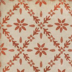 a red and white floral design on a beige background with orange flowers in the center