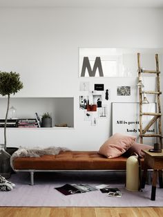 a bedroom with white walls and wooden floors