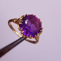 Outstanding stone ring from England. Gold is solid 10 kt yellow. Fine European workmanship. I bought the ring as a topaz, but I can't certify. The stone is a beautiful purple. The finger size is 6. Includes one year free sizing and maintenance by our goldsmith. Classic Solitaire Gemstones For Formal Occasions, Classic Solitaire Gemstones For Anniversary, Formal 14k Gold Amethyst Ring, Formal Solitaire Ruby Ring With Round Stone, Formal Crystal Ring With Birthstone In Round Cut, Formal 14k Gold Round Cut Gemstones, Formal 14k Gold Ruby Ring With Round Stone, Formal Yellow Gold Round Gemstones, Formal Yellow Gold Ruby Ring With Round Stone