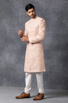 Dusty rose sherwani  with embroidered motifs. Paired with kurta and churidar.
Components: 3
Fabric: Pure Georgette
Neckline: Mandarin
Sleeve Length: Full
Color: Peach
Embroidered

Patch pocket - Aza Fashions Peach Sherwani, Embroidered Sherwani, Blouse Yoke, Modern Groom, Personal Shopping Service, Dusty Rose Color, Luxury Sale, Bespoke Tailoring, Churidar