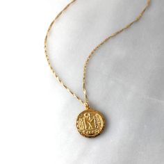 This gold pendant necklace is chic and stylish! A gold coin pendant graces a sparkling twist gold chain. Sure to be your favorite, this go with your favorite white tee or dressed too!•18kt gold over sterling silver coin pendant 22mm •A 14kt gold filled dainty singapore twist chain Everyday Gold Sterling Silver Coin Necklace, Everyday Gold Coin Necklace In Sterling Silver, Gold Medallion Coin Necklace With Cable Chain, Gold Medallion Charm Necklace With Cable Chain, Yellow Gold Plated Charm Necklaces With Coin Pendant, 14k Gold Coin Pendant Necklace For Everyday, Everyday 14k Gold Coin Necklace, Yellow Gold Plated Charm Necklace With Coin Pendant, Gold Tarnish-resistant 14k Gold-filled Coin Necklace