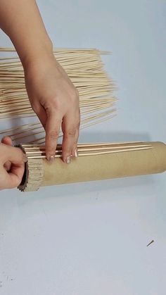 a person using a brush to clean a piece of wood