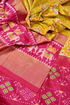 Get into the party mood with the new pure ikat silks like this one in yellow ochre and magenta color with allover ikkat weaving and peacock motif work on the entire pallu and border running through work with gap border to make it more fascinating. Color: A shade of yellow ochre and magenta color Technique: Amazing ikat weaving and ikat tie and dye work with zari work on the gap border Fabric: Ikat Silk Quality: Indyvogue's Assurance of Pure Silk Mark Certified Saree Navratri Silk Traditional Wear With Ikat Print, Navratri Ikat Print Silk Traditional Wear, Multicolor Ikat Print Traditional Wear For Festivals, Festive Silk Saree With Ikat Print, Silk Ikat Print Traditional Wear For Diwali, Ikat Print Silk Traditional Wear For Diwali, Festive Pink Ikat Print Dupatta, Bollywood Style Silk Traditional Wear With Ikat Print, Bollywood Traditional Wear In Silk With Ikat Print