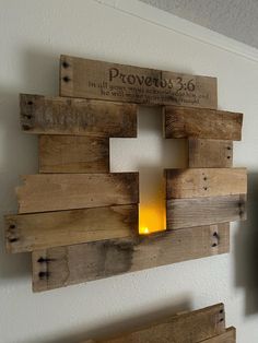 a cross made out of wooden pallets on the wall