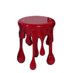 a red stool with dripping paint on it