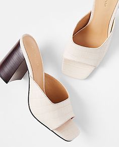 Step out in style and sophistication with the Ann Taylor Embossed Leather High Block Heel Mule Sandals. These sandals are a perfect blend of luxury and comfort, designed for the fashion-forward woman.

- Size: 10
- Color: Pearl Shadow
- Material: Embossed Leather
- Gender: Female
- Heel Height: 3 1/4 inches
- Features: Open toe, padded footbed for enhanced comfort

Crafted from high-quality embossed leather, these mule sandals feature a sturdy block heel that provides stability without sacrifici Summer Leather Block Heels With Almond Toe, Summer Block Heels With Reinforced Heel And Almond Toe, Chic Mules With Textured Footbed, Elegant Open Toe Heels With Textured Footbed, Block Heel Mule, High Sandals, Heeled Mules Sandals, Knitted Suit, Womens Mules