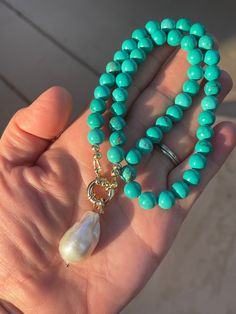 This necklace features beautiful 8mm round greenish-blue reconstituted turquoise, ending in a 14K gold-filled nautical clasp and featuring a large, 30mm white flameball baroque pearl with rainbow-hued nacre.  Please select your length from the drop-down menu. Your jewelry will come gift-boxed, and gift-wrapping is available upon request.  Thanks for checking out my shop! Elegant Turquoise Necklace With Lobster Clasp, Elegant Turquoise Necklace With Lobster Clasp For Gift, Elegant Blue Turquoise Necklace With Lobster Clasp, Elegant Blue Turquoise Necklace, Ethiopian Opal Earrings, Moonstone Drop Earrings, Pearl Charm Necklace, Black Pearl Necklace, White Pearl Necklace