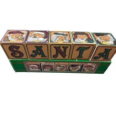 a wooden block with pictures of santa and other animals on it's sides, sitting in front of a white background