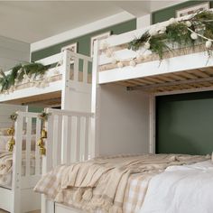 bunk beds are decorated with garlands and pine cones on the top, while another bed is in the background