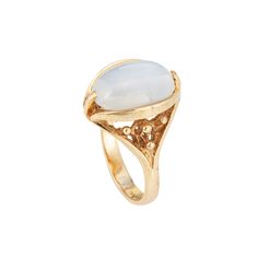 Stylish vintage moonstone cocktail ring (circa 1960s to 1970s) crafted in 10 karat yellow gold.  Cabochon moonstone measures 13.5mm x 9mm. The moonstone is in very good condition and free of cracks or chips.  The luminous moonstone glows with every movement of the hand, securely set in a bezel style mounting. The cocktail ring makes a nice statement on the hand. The medium rise ring (9mm - 0.35 inches) sits comfortably on the finger.   The ring is in very good condition and was lightly cleaned a Luxury Yellow Gold Cabochon Moonstone Ring, Ariana Grande Style, Gold Cocktail, Moonstone Ring, Cocktail Ring, Cocktail Rings, Rings Statement, Ariana Grande, Moonstone