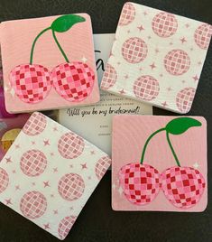 four coasters made to look like cherries with pink and white checkered fabric