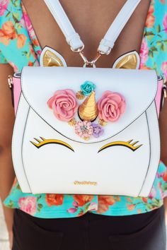 "After HIGH demand, we decided to bring our Unicorn Cake Bag back, so make sure to grab her while she's here. This Unicorn Bag is a 3-way multi-wearable bag with a tote, backpack and cross-body option! The front features two eyes with a golden horn and mini flower garden on the flap. The bag is held together with magnets on the flap and has a pink Esterhazy pattern on the interior and three interior pockets. * Please allow 1-2 days to process and ship DETAILS: -Microfiber faux leather piping, tr Black Unicorn Cake, Savory Cakes, Buckwheat Cake, Unicorn Fashion, Cake Bag, Unicorn Bag, Black Unicorn, Zucchini Cake, Magic Cake