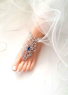 Something Blue Wedding Jewelry,Wedding Barefoot Sandals,Bridal Foot Jewelry,Rhinestone Silver Foot Jewelry,Footless Sandal,Beach Sandals-SD032 This stunning Blue color rhinestone footless sandals is the perfect accessory for a beach or garden wedding. This sandal has colored rhinestones in the center and clear rhinestones around it. It is very comfortable and adjustable. Silver Model Size is US 7.5 Sandals are made with the rhinestone with Silver plating. Quantity: One order is one pair (2 pcs). Elegant Crystal Sandals For Wedding, Elegant Crystal Wedding Sandals, Wedding Barefoot Sandals With Rhinestones, Adjustable Rhinestone Barefoot Sandals For Wedding, Blue Open Toe Barefoot Sandals For Party, Crystal Open Toe Sandals For Wedding, Silver Toe Ring Sandals For Wedding, Blue Summer Wedding Jewelry, Sandals Bridal