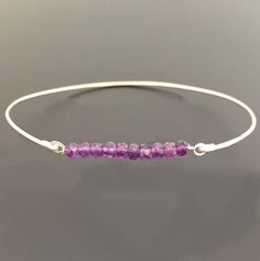 Amethyst Bead Bracelet - Amethyst Bracelet - February Birthstone Jewelry - A row of 10 faceted amethyst gemstone beads has been transformed into an elegant amethyst beaded bangle bracelet with your choice of sterling silver or 14k gold filled bangle band. Perfect for a February birthstone bracelet.This February amethyst jewelry can be personalized with an initial dangle. Simply add to cart to make a customized amethyst beaded bracelet;http://www.etsy.com/listing/84670605/add-an-initial-charm-to- Adjustable Amethyst Beaded Bracelets With Birthstone, Purple Beaded Birthstone Bracelets As Gift, Purple Beaded Birthstone Bracelets For Gift, Purple Birthstone Beaded Bracelets As Gift, Purple Birthstone Beaded Bracelets For Gift, Spiritual Amethyst Beaded Birthstone Bracelet, Purple Amethyst Birthstone Bracelet, Purple Rondelle Beaded Bracelets As Gift, Adjustable Amethyst Rondelle Bracelets