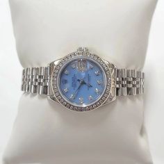 Women's Rolex 26mm DateJust Stainless Steel Watch with Powder Blue Diamond Dial and Diamond Bezel. Pre-Owned Brand: Rolex. Crystal: Sapphire. Dial: Diamond Dial. Gender: Women's. Dial Color: Powder Blue. Movement: Self-Winding. Case Dimensions: 26mm. Metal Type: Stainless Steel. Bezel: Custom Diamond Bezel. Bracelet / Strap: Original Jubilee. Box / Certificate: Rolex Box / Certificate of Authenticity. Service Warranty: One (1) Year Limited Service Warranty. NOTE: This beautiful Rolex watch inclu Blue Diamond Chronometer Watch For Formal Occasions, Formal Blue Diamond Watch With Chronometer, Blue Diamond Watch With Round Dial, Blue Diamond Watch With Diamond Hour Markers For Anniversary, Blue Diamond Watch For Anniversary, Blue Diamond Watch With Round Subdials, Blue Diamond Watch With Subdials, Timeless Blue Diamond Watch With Chronometer, Blue Diamond Watch With Diamond Hour Markers