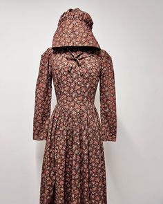 Rare 1970s brown floral prairie maxi cotton dress with matching bonnet. So good!  Back Talon zip. Condition: Good, has some minor wear reflected in photos. (may show signs of wear - but in general good vintage condition) Measurements flat lay: Shoulders: 13" Pit to pit: 16" Waist: 25" Length: 55.5" Sleeve length: 22.5" Fitted Brown Prairie Dress For Fall, Fitted Vintage Brown Prairie Dress, Fitted Brown Vintage Prairie Dress, Vintage Brown Prairie Dress For Fall, Brown Vintage Prairie Dress For Fall, Vintage Cotton Victorian Dress For Fall, Vintage Victorian Cotton Dress For Fall, Maxi Cotton Dress, Maxi Dress Cotton