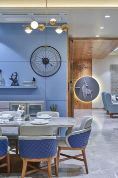 a dining room with blue walls and chairs