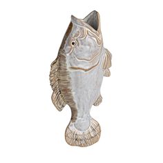 a fish shaped vase sitting on top of a white table