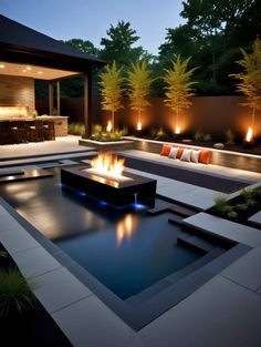 an outdoor fire pit in the middle of a patio with lights on and seating around it