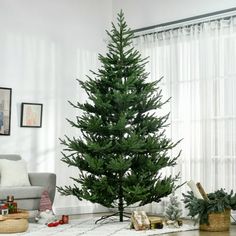 a living room with a christmas tree in the corner and other decorations on the floor