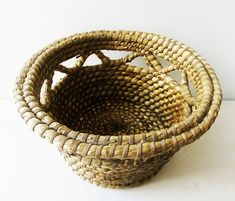 a woven basket sitting on top of a white table