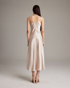 This elegant bias-cut slip dress features a spaghetti strap and flattering V Neck for a fresh, yet refined look. This perfect basic can be worn for life, dressed up, or dressed down, for the perfect effortless ensemble. 100% Silk Charmeuse Made in New York City Product Care: Dry Clean Only Formal V-neck Slip Dress With Delicate Straps, Sleeveless Solid Slip Dress With Bias Cut, Chic Solid Color Bias Cut Slip Dress, Elegant Silk Dress With Spaghetti Straps For Daywear, Solid Silk Midi-length Slip Dress, Elegant Sleeveless Slip Dress For Daywear, Solid Color Camisole Slip Dress For Evening, Elegant Cami Dress With Delicate Straps, Classic Sleeveless Bias Cut Slip Dress