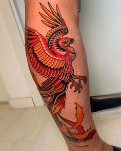 a bird tattoo on the leg of a person