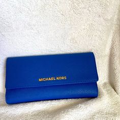 Mk Wallet Bag Nwt Never Used (Check Closet For Matching Tote Bag)!!! Whether It's A Trip To Rome Or The Corner Store, This Jet Set Wallet From Michael Michael Kors Works Any Look You Like. Luxe Saffiano Leather Is Fronted By Gilded Logo Lettering, While The Organized Interior Keeps Your Financials In Check. (Send Me A Offer!!) Michael Michael Kors Wallet Saffiano Leather Magnetic Snap Closure Gold-Tone Hardware; Back Zip Pocket; Logo Plaque At Front Interior Features Bill Compartment And 8 Card Classic Blue Clutch For Travel, Classic Blue Travel Clutch, Classic Blue Bags With Card Slots, Travel Blue Clutch, Michael Kors Wallet With Removable Pouch, Michael Kors Wallet With Removable Pouch For Everyday Use, Michael Kors Bag With Card Slots For Daily Use, Everyday Michael Kors Rectangular Clutch, Michael Kors Daily Use Bag