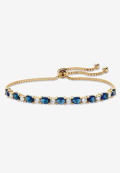 Color the day with classic style and vibrant color with this beautiful slider bracelet. Glimmering simulated blue sapphires and sparkling cubic zirconia ovals alternate on the adjustable bolo strand featuring ball ends that dangle in cool style. 6.20 carats T.W. 10" length. Richly plated in 14k yellow gold.14k Gold-PlatedMain Stone: 9 Oval Faceted Cut Simulated Blue Sapphires, 5.40 carats total weight, 6 mm x 4 mm8 Round Brilliant Cut Cubic Zirconias, .80 carat total weight, 3 mm x 3 mmDimension Adjustable Blue Round Tennis Bracelet, Adjustable Blue Tennis Bracelet, Adjustable Sapphire Bracelets For Formal Events, Adjustable Sapphire Bracelets For Formal Occasions, Gold And Blue Jewelry, Blue Jewlery, Blue And Gold Jewelry, Ball Jewellery, Dr Accessories