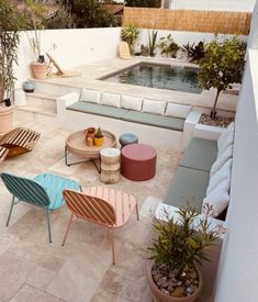 an outdoor seating area with potted plants and pool