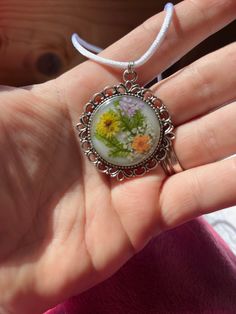 Lovely tiny dried flowers suspended in a filigree silver-tone bezel; hung on 22-inch white satin cord with lobster-claw clasp. White Spring Bouquet, Spring Bouquet, Resin Pendant, Silver Filigree, White Satin, Lobster Claw, Dried Flowers, Pendant Necklaces, Favorite Jewelry