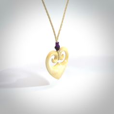 Love Carved in Ancient Material Love is eternal with IMMORTAL's beautiful Woolly Mammoth tusk heart pendants, hand carved with intricate koru filigree for a truly special token of affection. Show the one you love that your bond is unbreakable. We had our mammoth material carbon dated to get an accurate measure of its age. The testing was done for us by GNS Science, a New Zealand Crown Research Institute and New Zealand's leading provider of Earth, geoscience and isotope research - so their assessment of this material is as accurate as is possible using radiocarbon dating technology. The Mammoth Tusk used for this piece is CERTIFIED 34,690 YEARS OLD (+/- 815 years). The perfect gift for someone very special, or a beautiful and meaningful jade pendant for yourself. We provide these with Pale Wooly Mammoth, Jade Pendant, After Dark, Hand Made Jewelry, Heart Jewelry, Brown Color, Heart Pendant, Lilac, Hand Carved