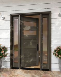 the front door to a house with two flower pots