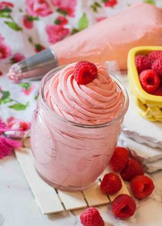 raspberry ice cream in a jar with fresh raspberries on the side